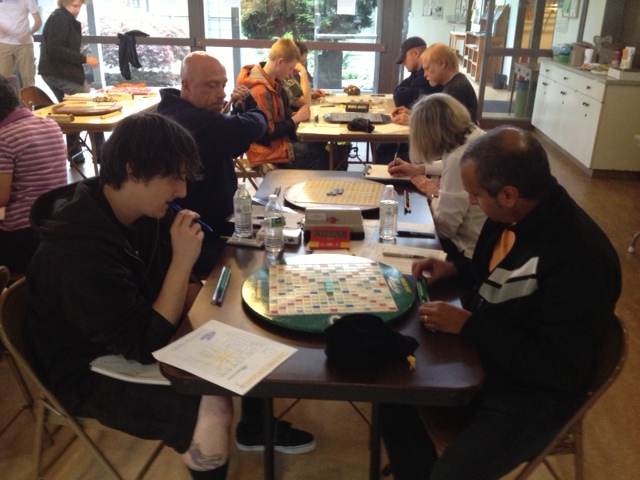 Kolton Koehler v. Sudhir Padmanabhan in front of Jim Porter and Jill Turney, with Alec Sjöholm v. Ken Clark at the table behind them